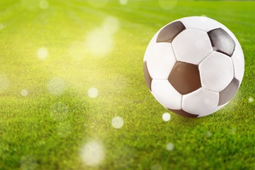 Football field with soccer ball close-up view