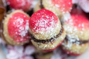 Close up of raw vegan peaches cookies on a white table. Pink peach cookie for vegans. Raw food sweets.