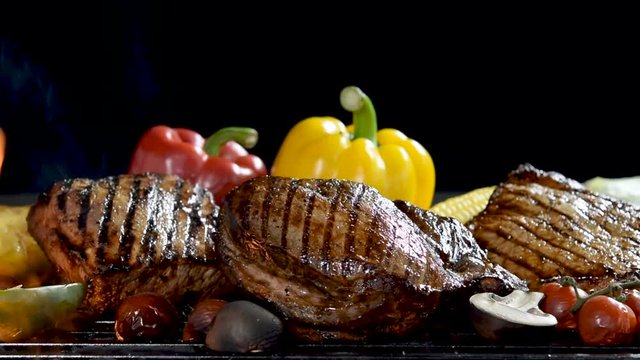 Grilled meat /steak with vegetable on the flaming grill .