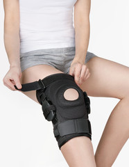 Knee Support Brace on leg isolated on white background. Orthopedic Anatomic Orthosis. Braces for...