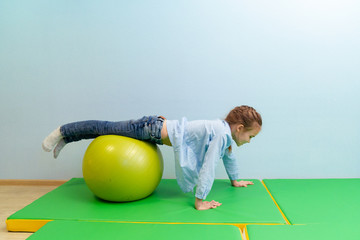 teen girl engaged in physical therapy on ball - obrazy, fototapety, plakaty