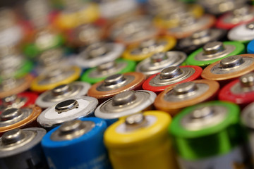 Many multicolored used batteries