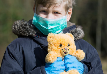 Child in protective sterile medical mask