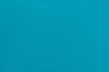 Blue homogeneous background with a textured surface, fabric.