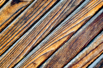 Fototapeta premium The old wooden surface is a door made of burnt planks