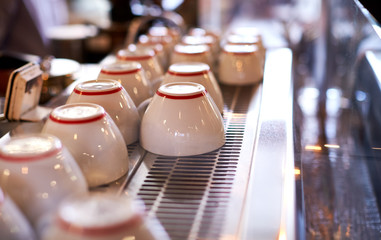 Close Up Of Cups Arranged On Machine In Coffee Shop