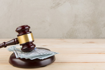 Judge gavel and money on wooden table - auction concept