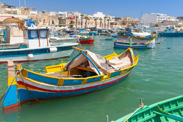 Fototapeta na wymiar Аishing boats moored in Marsaxlokk, Malta
