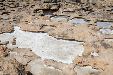 Salt is on coastal rocks on a sea coast