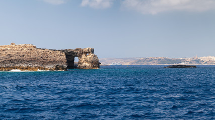 Fototapeta na wymiar Natural stone arch on a coast of Comino island, Malta