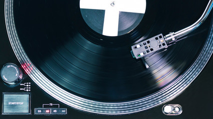Close-up of modern turntable vinyl record player with music plate. Needle on a vinyl record