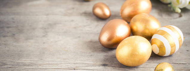 easter eggs colored with golden paint in differen patterns. Copy space.