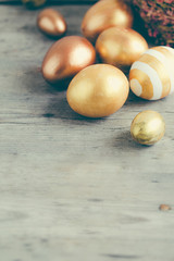 easter eggs colored with golden paint in differen patterns. Copy space.