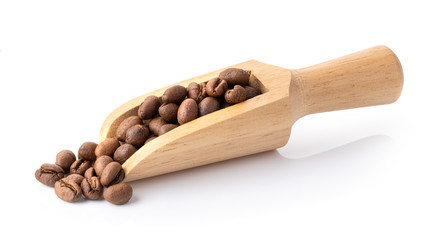 roasted coffee beans in wood scoop isolated on a white background