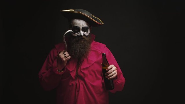 Drunk bearded man dressed up like a pirate with a hook