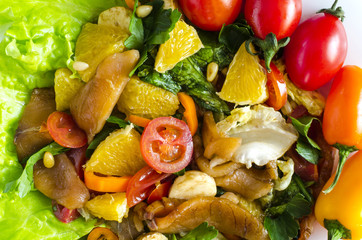 appetizer with fish and vegetables on a white plate decorated with tomatoes, herbs and sweet peppers close- up