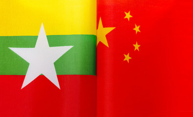 fragments of the national flags of Myanmar and China close up