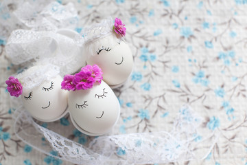Easter decoration, white eggs with wreaths on a light gray background