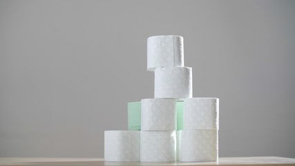 Many tubes of toilet paper. Stack of toilet paper rolls against a gray background. Coronavirus or COVID-19. Pandemic worldwide, panic. Recycling. Epidemic situation. 
