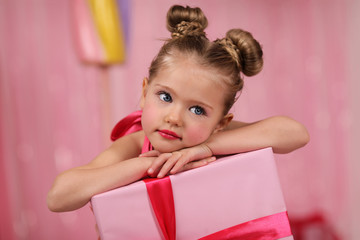 portrait of a girl-model, having fun at a birthday party in a beautiful, delicious, pink candy interior, the concept of themed children's holidays, participation in competitions.