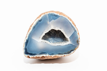 Blue colored geode outside looking like usual rock inside full of crystals