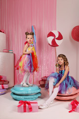 girls-models have fun at a birthday party in a beautiful, delicious, pink candy interior, the...