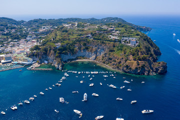 Aerial Drone photo of the beautiful island of ischia with blue sea and skies with hundreds of boats...