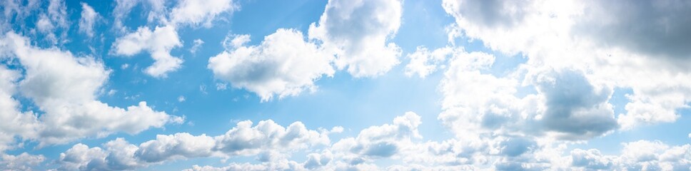 gorgeous panorama of cloudscape in springtime. weather background with dynamic cloud arrangement on a blue sky. sunny and windy day, good weather forecast concept