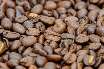 Close up of dark coffee beans dark roasted seeds