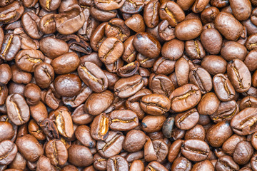 Coffee beans roasted dark brown seeds close up background texture