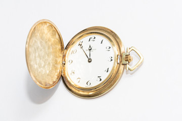 Old golden pocket watch manufactured in switzerland colored golden five minutes to midnight