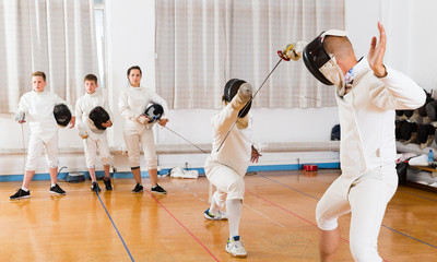 fencers watching at fencing duel