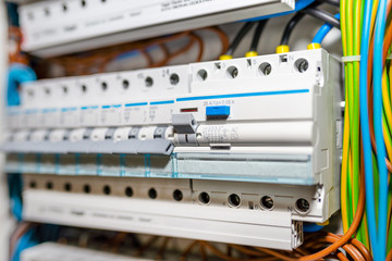 Single phase fuses in OFF position and residual current protection in ON position. Many gray...