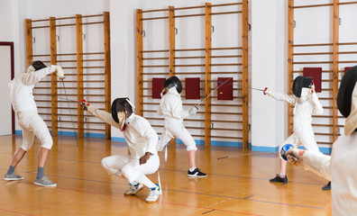  fencers practicing rapier blows in pairs