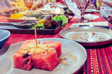Fried dried fish with watermelon served as a dessert for party dinner in the restaurant