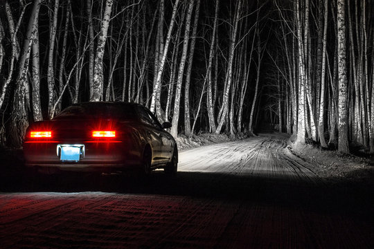 White Sports Car On A Country Road, In A Night Birch Forest