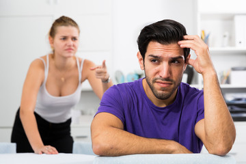 Frustrated guy at table with dissatisfied girlfriend
