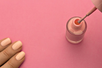 Pink nail polish on pink background cosmetic