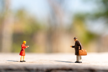 Obraz premium Miniature people greeting to keep social distancing to protect from COVID-19 coronavirus