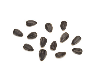 Obraz premium fried black sunflower seeds unpeeled, close-up on white background