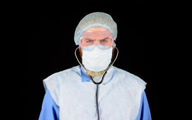 Doctor in protective suit and medical mask. Healthcare and medicine concept. Medical doctor with stethoscope in hospital. Diagnostic instrument, hospital equipment. Advertising hospital, clinic.