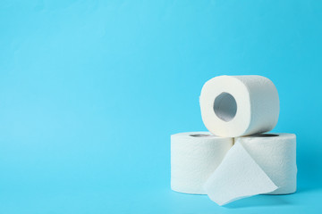 Toilet paper on blue background, space for text