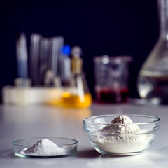 Sport Nutrition Supplement in lab. Creatine powder and whey protein powder on lab background