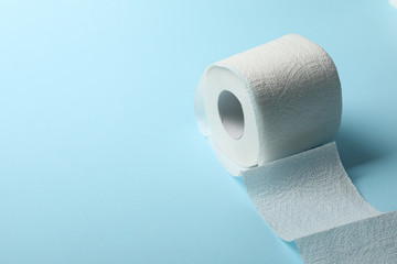 Toilet paper on blue background, space for text