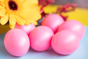 Easter background with painted easter eggs and flowers.
