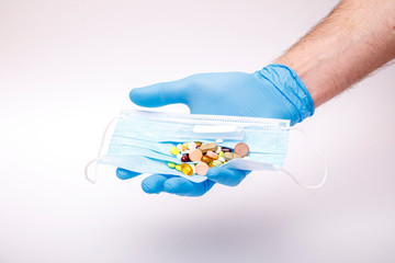 Man hold medical flu dose of medicine or treatment drug concept in hand with protective glove. Coronavirus problem and covid-19 protection concept.