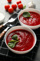 Tomato cream soup on grey background. Healthy food