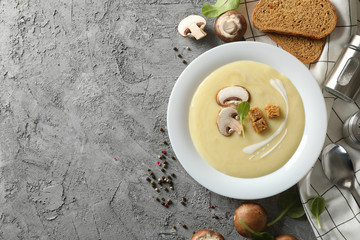 Mushroom cream soup and ingredients on grey background, top view