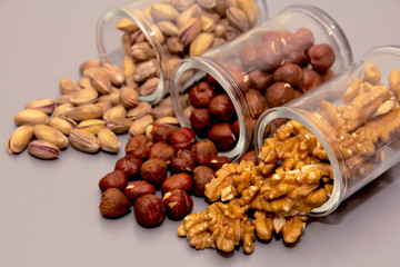 hazelnut, walnut and pistachio nut. mixed assorted nuts in glass box on light background.
