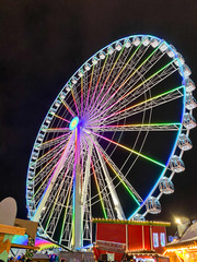 colorful ferris wheel at night. Amusement park.